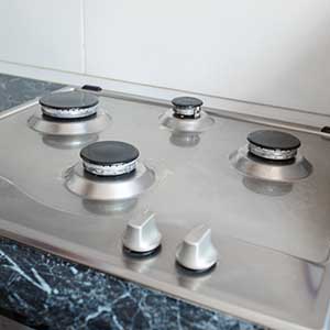 polished gas cooker after washing.perfectly clean gas cooker after being washed with polishing chemicals. the result of washing the burners.